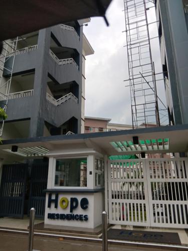 a hdp properties building in front of a building at Brittany Bliss Staycations at SMDC HOPE RESIDENCES in Trece Martires