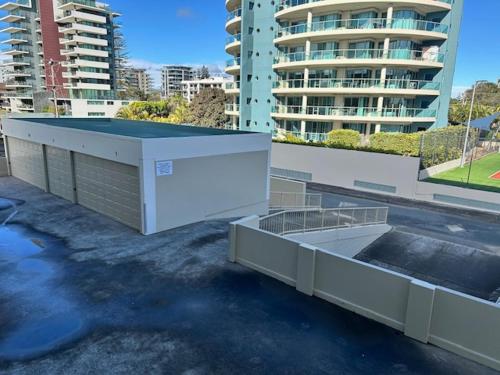 arial view of a building in a city with buildings at Beachfront Oceanic 5 in Forster