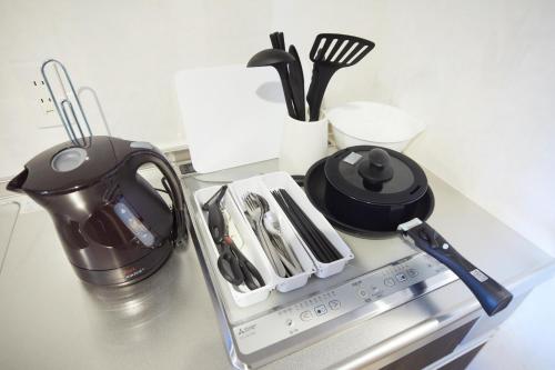 a counter top with a tea kettle and utensils at SG Premium KASAI - Vacation STAY 44353v in Tokyo
