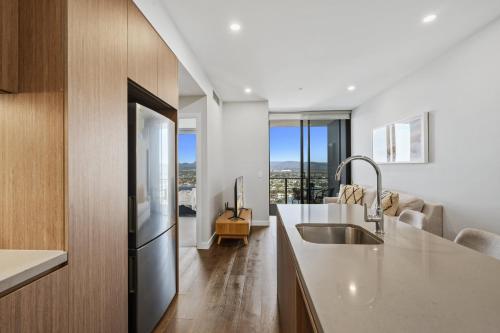 a kitchen with a sink and a counter at Modern 1 Bedroom Unit at The Casino - NO PARKING - Q Stay in Gold Coast