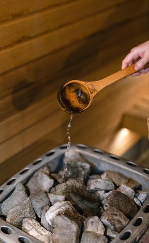 a person holding a spoon with water coming out of a pan at Amora Hotel Brisbane in Brisbane