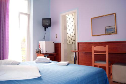 Ένα ή περισσότερα κρεβάτια σε δωμάτιο στο Diethnes Hotel 