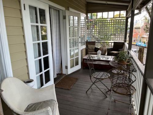 a screened porch with chairs and a table on a house at Wenlock in Sydney