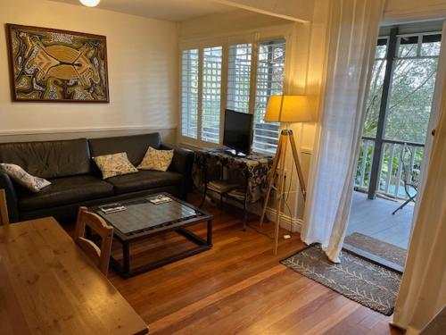 a living room with a couch and a table at Wenlock in Sydney