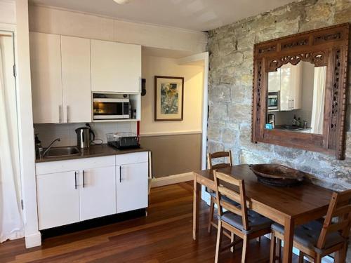 a kitchen with a wooden table and a dining room at Wenlock in Sydney
