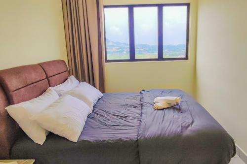 a bed in a room with a window at Warm Nest near KLIA at Youth City Nilai by HCK in Nilai