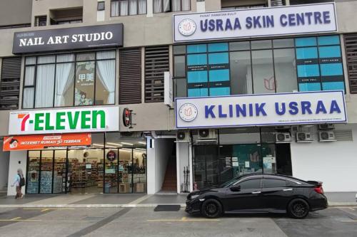 a black car parked in front of a building at Warm Nest near KLIA at Youth City Nilai by HCK in Nilai