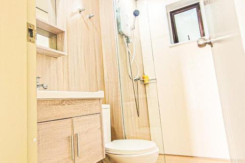 a small bathroom with a toilet and a shower at Warm Nest near KLIA at Youth City Nilai by HCK in Nilai