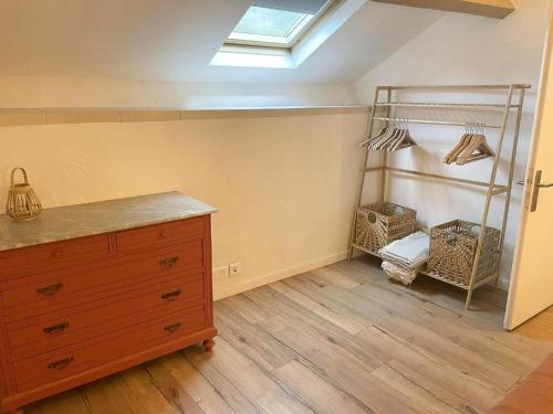 a attic room with a dresser and a skylight at 17Th Century Renovated Barn In Valdeblore in Valdeblore