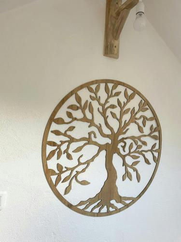 a wooden wall art of a tree on a wall at 17Th Century Renovated Barn In Valdeblore in Valdeblore