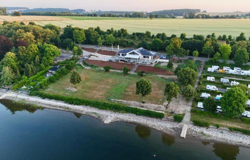 an aerial view of a house on an island in the water at Wellness Lodge, Sauna, Whirlpool nahe dem Möhnesee in Möhnesee