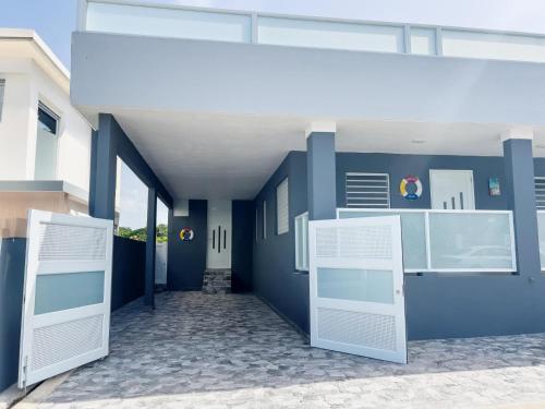 a blue building with two doors and a hallway at Tres Propiedades, Brisas del Mar l, Brisas del Mar II & Brisas del Mar lll in Fajardo