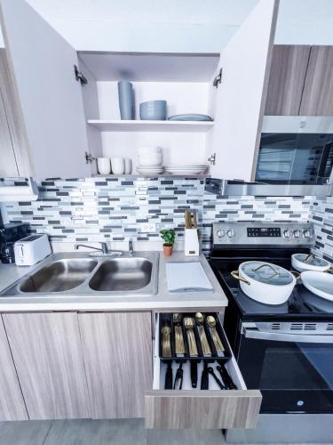 a kitchen with a sink and a stove at Tres Propiedades, Brisas del Mar l, Brisas del Mar II & Brisas del Mar lll in Fajardo