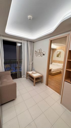 a living room with a couch and a bed at Fantasea Condo Kamala beach 1BR apart B1 in Kamala Beach