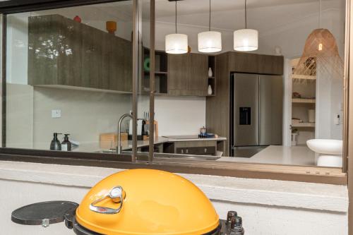 a yellow helmet sitting on a counter in a kitchen at Tranquil Noosa at its best Beach, Bush, Good Food. in Noosa Heads