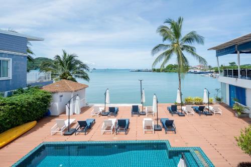 a view of the ocean from the balcony of a resort at Phuket Boat Quay Hotel Panwa Beach in Panwa Beach