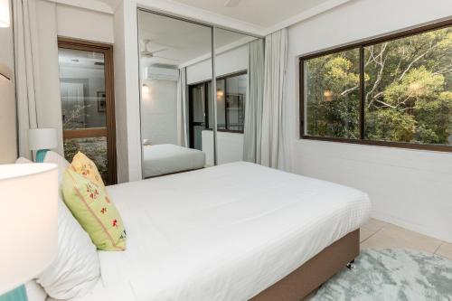 a bedroom with a bed and a large window at Tranquil Noosa at its best Beach, Bush, Good Food. in Noosa Heads