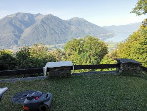 a toy train sitting on the grass next to a bench at Helle Sonne in Agarone