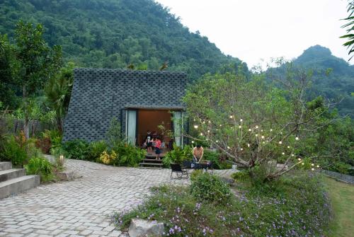 a house with a stone patio in a garden at Warm Season 