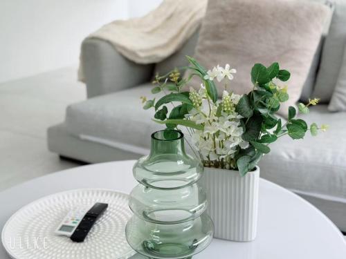 a glass vase sitting on a table with a vase at Cozy 4B Villa close to Theme Park in Pimpama