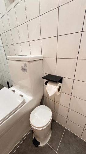 a bathroom with a toilet and a sink and a toilet paper roll at Fantasea Condo Kamala beach 1BR apart B1 in Kamala Beach