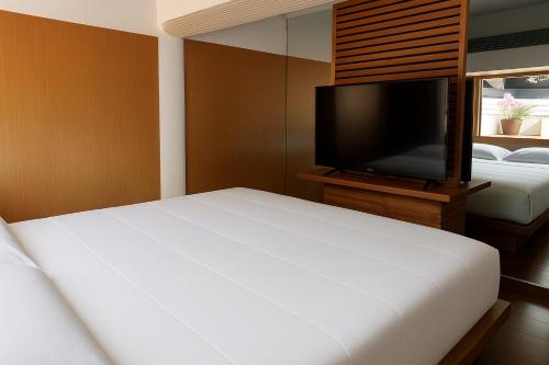 a bedroom with a bed and a flat screen tv at cloud and wind in Yangzhou