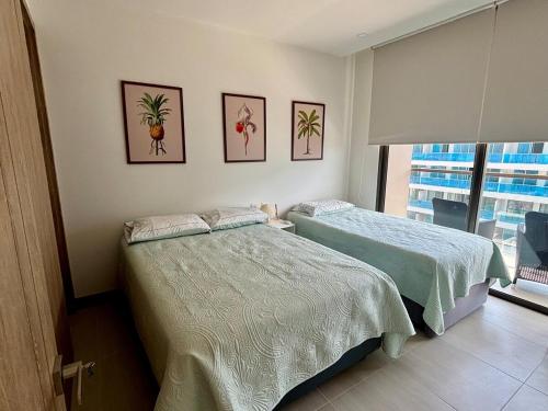 Postel nebo postele na pokoji v ubytování Beachfront Stay Morros EOS