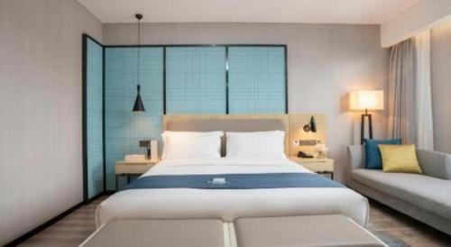 Ένα ή περισσότερα κρεβάτια σε δωμάτιο στο Echarm Hotel Jianshui Gucheng