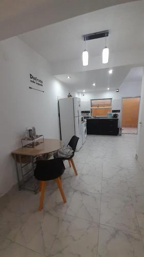 a large room with a table and a refrigerator at Casa Duplex AMOBLADO en San Salvador de Jujuy Barrio Las Marias in San Salvador de Jujuy