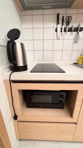a kitchen counter with a sink and a microwave at Fantasea Condo Kamala beach 1BR apart B1 in Kamala Beach
