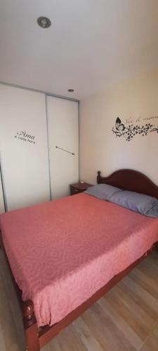 a bedroom with a bed with a red blanket at Casa Duplex AMOBLADO en San Salvador de Jujuy Barrio Las Marias in San Salvador de Jujuy