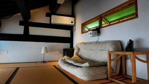 a living room with a white couch and a window at cloud and wind in Yangzhou