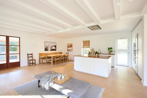 a living room with a kitchen and a table at Modern Summer House On Stunning 3700 M2 Plot in Frederiksværk