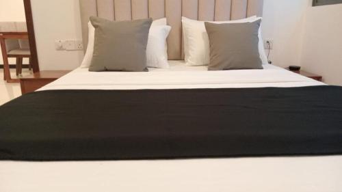 a large bed with white sheets and pillows at Colombo, Trizen Luxury Apartments, Sri Lanka in Colombo