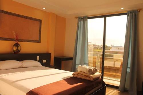 a bedroom with a bed and a large window at Hotel Stella blu in Manta