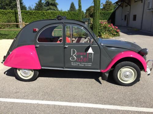 a small car is parked in a parking lot at Domaine de Suzel in Vignieu