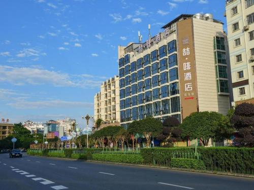 a large building on the side of a street at James Joyce Coffetel Guilin Railway Station Xiangbi Mountain Liangjiang Sihu Wharf in Guilin