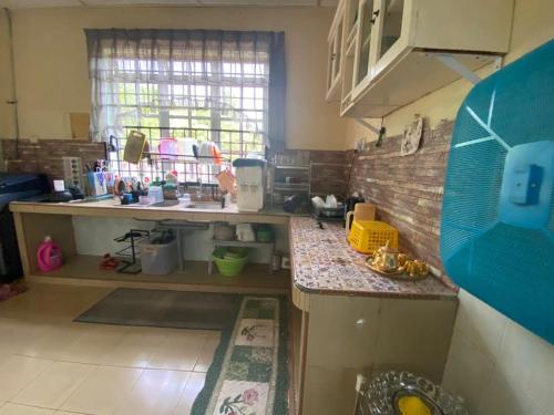 a kitchen with a sink and a counter top at Ariniz Homestay Beserah in Beserah