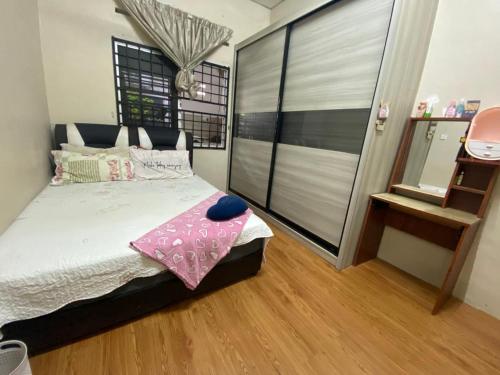 a bedroom with a bed and a large window at Ariniz Homestay Beserah in Beserah