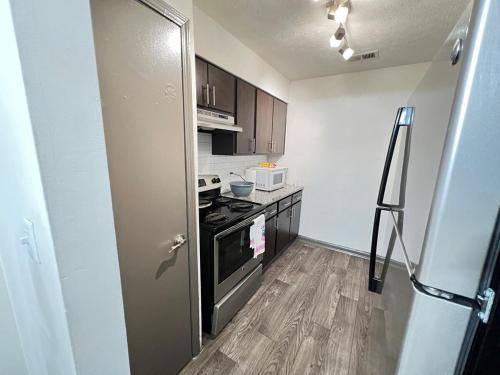 a small kitchen with a stove and a refrigerator at Entire cozy 2-bedroom Guest house in Atlanta in Atlanta