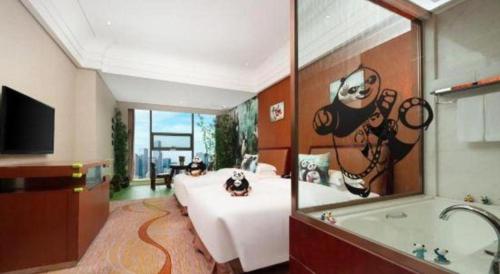 a large room with a bed and a bath tub at Balan International Hotel in Dujiangyan