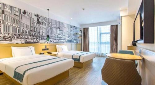 une chambre d'hôtel avec deux lits et une table dans l'établissement City Comfort Inn Zhanjiang International Trade Dingsheng Plaza, à Zhanjiang
