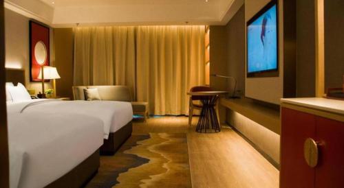 Ένα ή περισσότερα κρεβάτια σε δωμάτιο στο Echeng Hotel Enshi Minzu Road