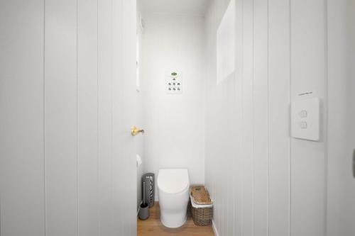 a white bathroom with a toilet in a room at Magical Dome At Petrichor Estate in Bald Knob