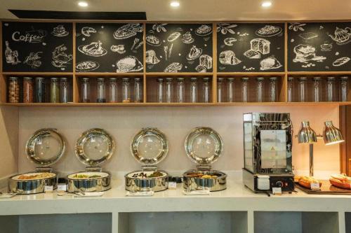 a counter with several plates of food on it at Borrman Hotel Zoucheng Huamaowan Mall in Jining