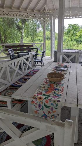 a picnic table with a rug on a patio at Pastoral wooden hauses in Velikiy Les
