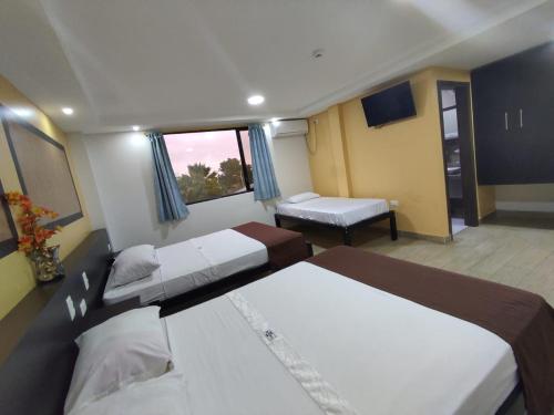 a hotel room with two beds and a window at Hotel Stella blu in Manta