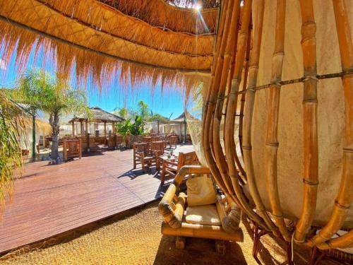 aentedented deck with a chair and tables and a patio at Flamingo Suites in Marina di Camerota