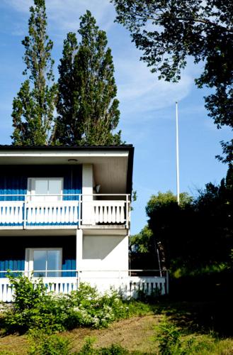 a white house with a balcony on the side of it at Ekebacken Hotell & Konferens in Markaryd
