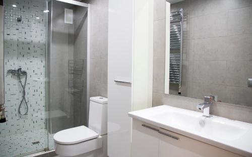 a bathroom with a toilet and a sink and a shower at Apto. Santa Susanna in Santa Susanna
